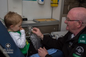 Shay shows Charlie some of the equipment used by St John Ambulance